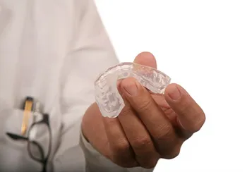 dentist holding nightguard